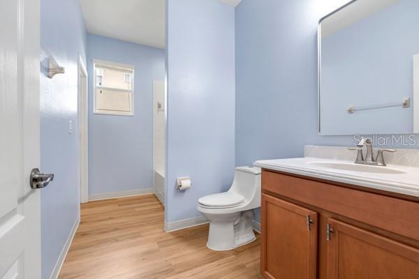 5839 Tarleton Way, Mount Dora, FL 32757 - full bath with toilet, wood finished floors, vanity, and baseboards