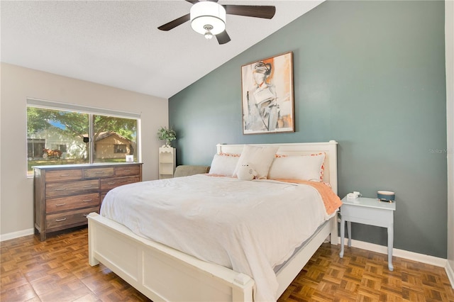 bedroom featuring baseboards, a ceiling fan, and lofted ceiling
