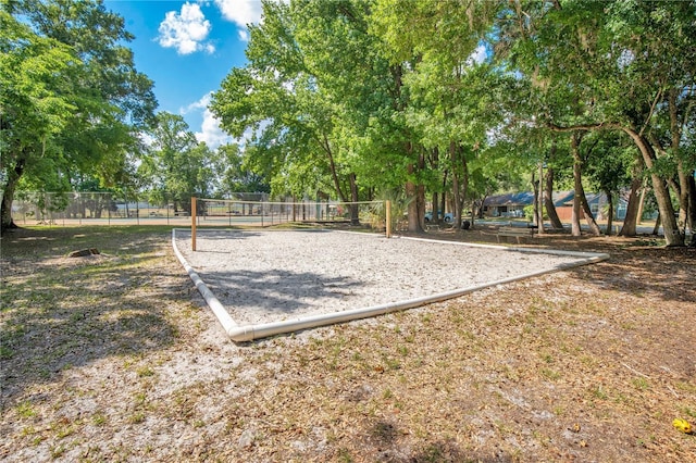 view of community featuring volleyball court and fence