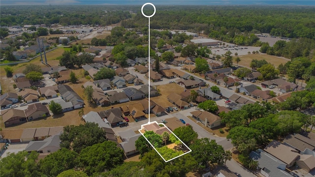 aerial view featuring a wooded view and a residential view