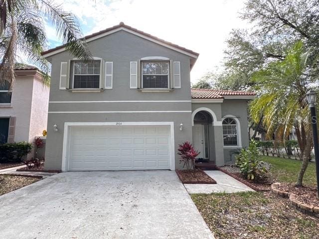2904 Cayenne Ave, Pembroke Pines, FL 33026 - view of front facade featuring a tile roof, concrete driveway, stucco siding, and an attached garage