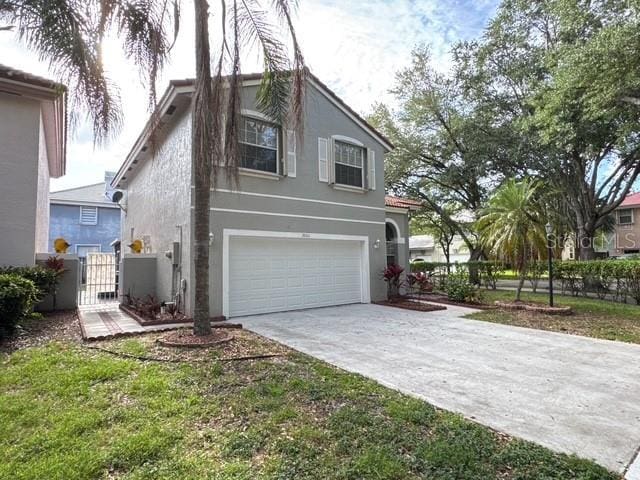 2904 Cayenne Ave, Pembroke Pines, FL 33026 - view of property exterior featuring a gate, stucco siding, driveway, and an attached garage