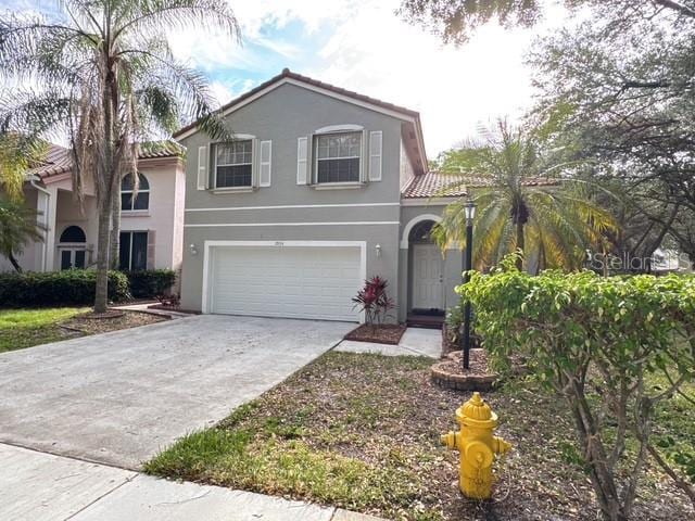 2904 Cayenne Ave, Pembroke Pines, FL 33026 - view of front of home featuring stucco siding, a tile roof, concrete driveway, and an attached garage