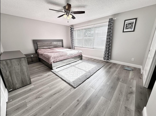 2904 Cayenne Ave, Pembroke Pines, FL 33026 - bedroom with a textured ceiling, wood finished floors, a ceiling fan, and baseboards