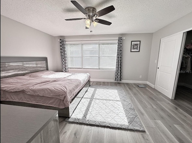 2904 Cayenne Ave, Pembroke Pines, FL 33026 - bedroom featuring a textured ceiling, wood finished floors, ceiling fan, and baseboards
