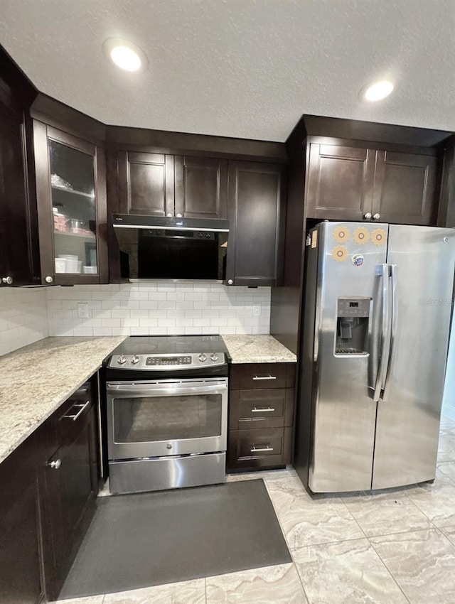 2904 Cayenne Ave, Pembroke Pines, FL 33026 - kitchen featuring exhaust hood, dark brown cabinets, appliances with stainless steel finishes, and decorative backsplash