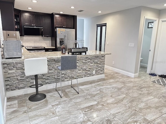 2904 Cayenne Ave, Pembroke Pines, FL 33026 - kitchen with recessed lighting, visible vents, light stone counters, and appliances with stainless steel finishes