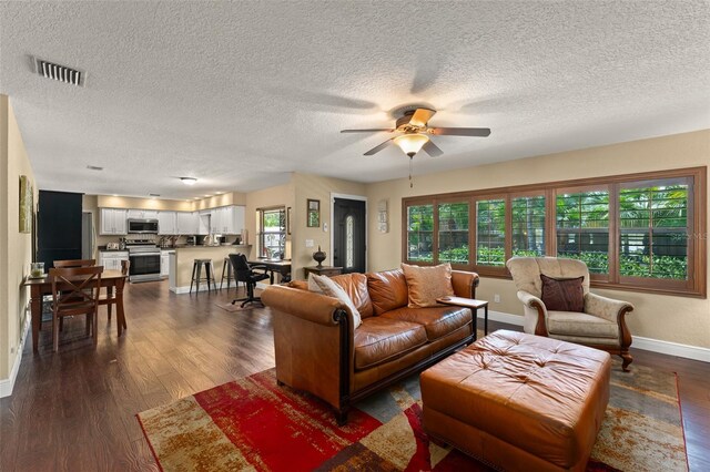 195 E Faith Ter, Maitland, FL 32751 - living room with visible vents, baseboards, ceiling fan, dark wood-type flooring, and a textured ceiling