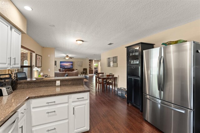 195 E Faith Ter, Maitland, FL 32751 - kitchen featuring freestanding refrigerator, a peninsula, a healthy amount of sunlight, and dark wood-style flooring