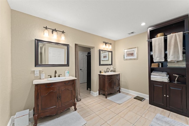 195 E Faith Ter, Maitland, FL 32751 - bathroom featuring visible vents, a sink, two vanities, and tile patterned floors