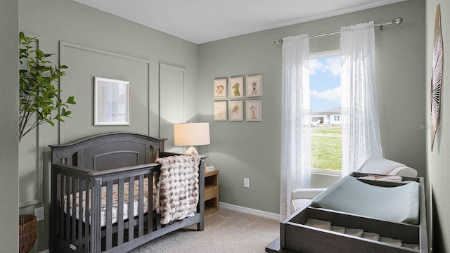 33620 Seattle Slew Dr, Sorrento, FL 32776 - carpeted bedroom featuring baseboards and a crib