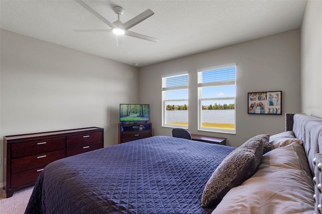 bedroom with ceiling fan and light carpet