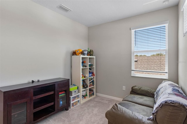 sitting room with baseboards, carpet, and visible vents