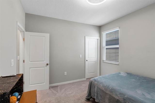 bedroom with baseboards and carpet flooring