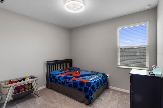 bedroom with baseboards and carpet flooring
