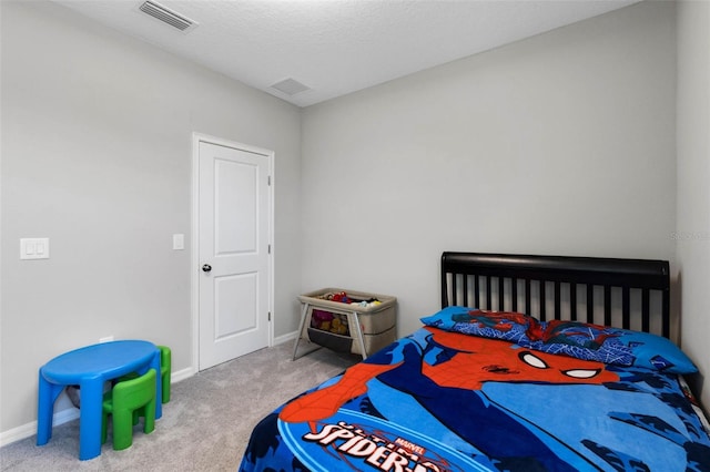 carpeted bedroom with visible vents and baseboards