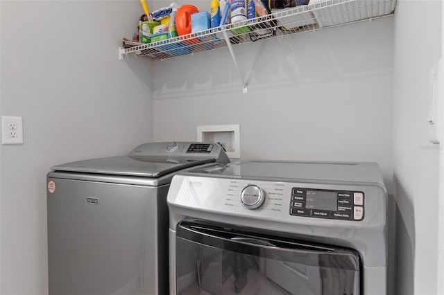 clothes washing area featuring washer and dryer and laundry area