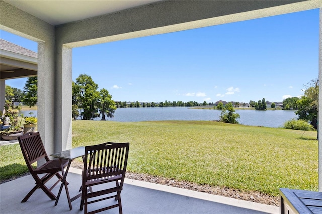 exterior space featuring a water view and a patio area
