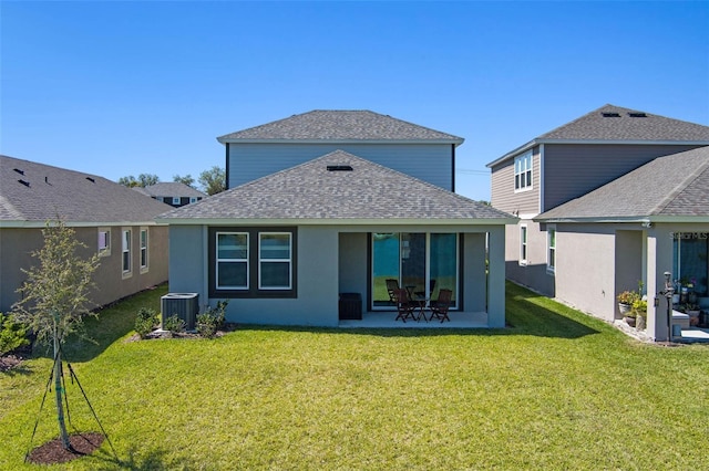back of property featuring central AC unit, a yard, a patio, a shingled roof, and stucco siding