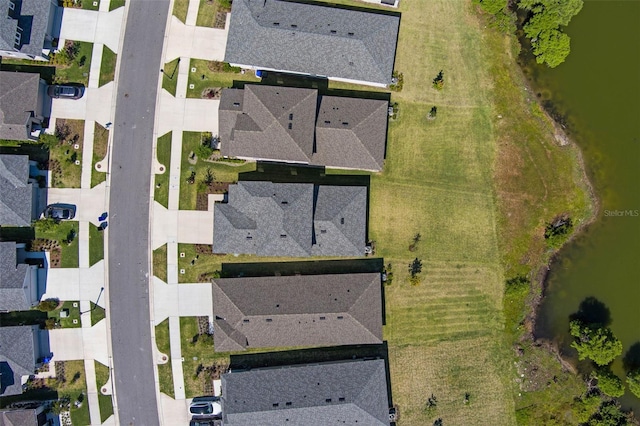 drone / aerial view featuring a water view and a residential view