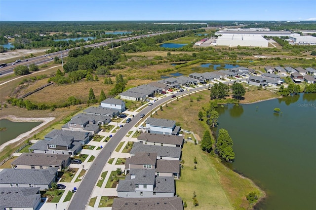 drone / aerial view with a residential view and a water view