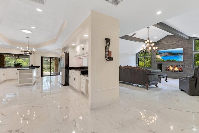 2108 Silver Leaf Ct, Longwood, FL 32779 - living area featuring baseboards, an inviting chandelier, lofted ceiling with beams, and a fireplace