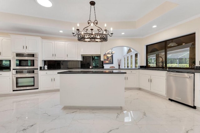 2108 Silver Leaf Ct, Longwood, FL 32779 - kitchen with decorative backsplash, dark countertops, white cabinetry, a chandelier, and appliances with stainless steel finishes