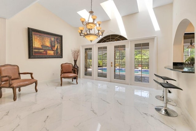 2108 Silver Leaf Ct, Longwood, FL 32779 - sitting room with french doors, a skylight, arched walkways, marble finish floor, and an inviting chandelier