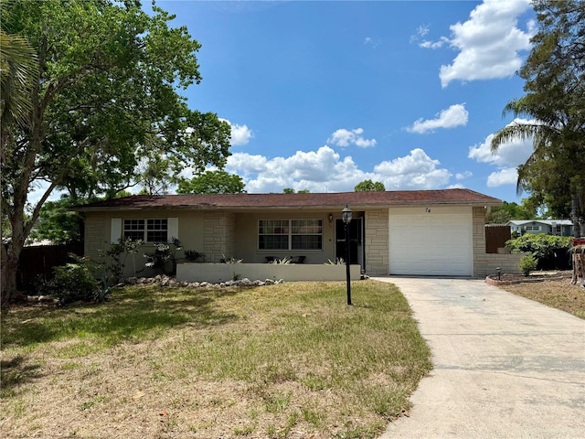 single story home featuring a front lawn, driveway, a garage, and fence