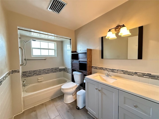 full bath with tile walls, vanity, shower / bath combination, toilet, and visible vents