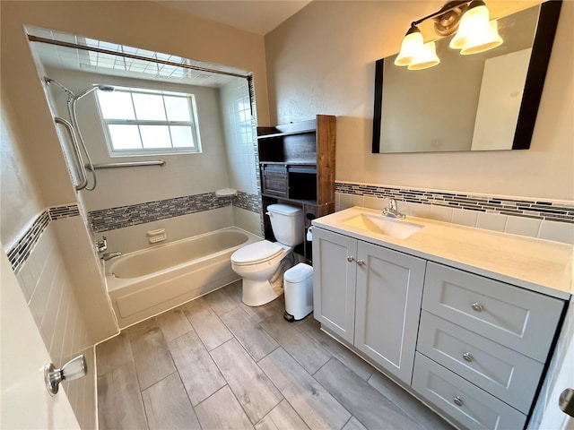 full bath featuring toilet, tile walls, wood finished floors, and vanity