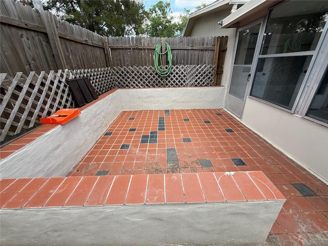 view of patio featuring fence