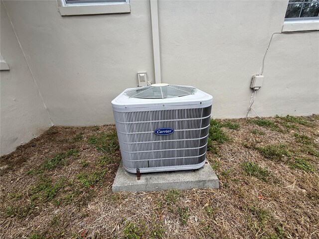 details featuring stucco siding and central air condition unit