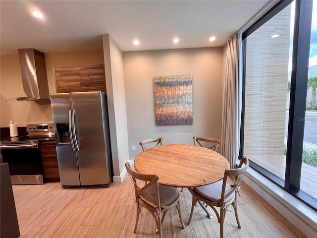 dining space with light wood finished floors, recessed lighting, and baseboards