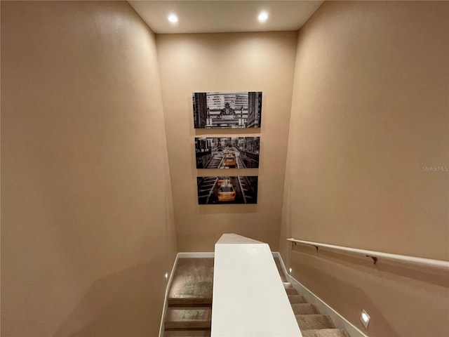 stairs with baseboards and recessed lighting