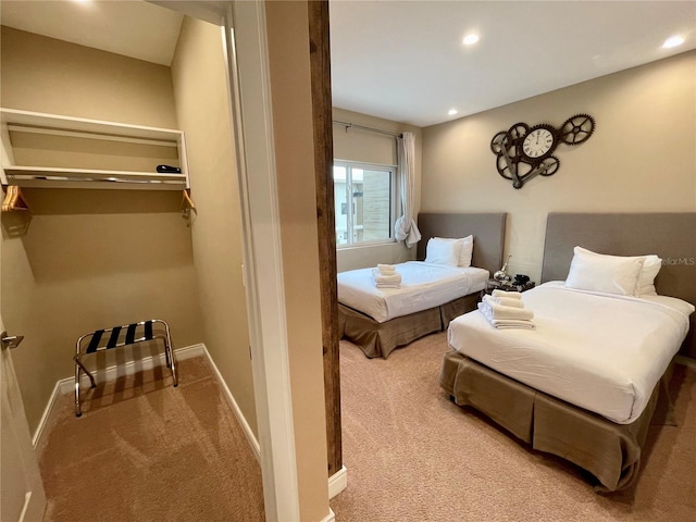 carpeted bedroom featuring baseboards and recessed lighting