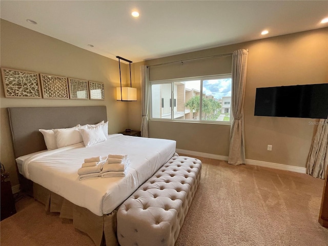 bedroom featuring light colored carpet, recessed lighting, and baseboards