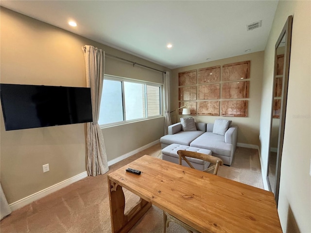 living area with visible vents, baseboards, recessed lighting, and light carpet