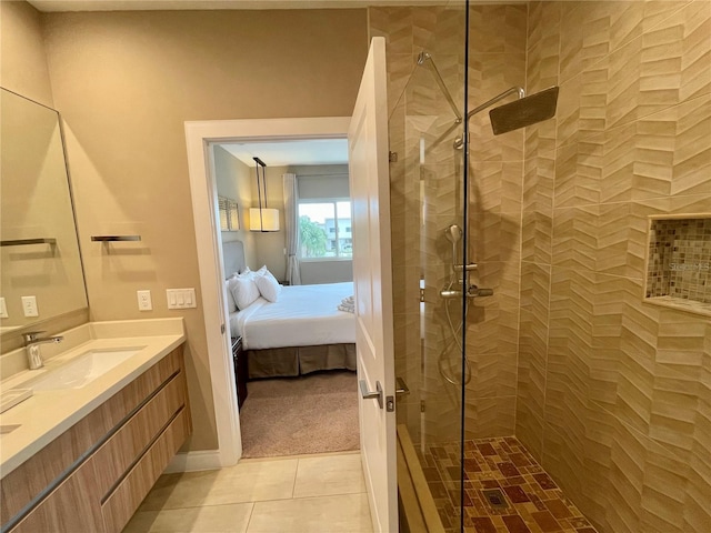 full bath featuring a walk in shower, vanity, ensuite bathroom, and tile patterned flooring
