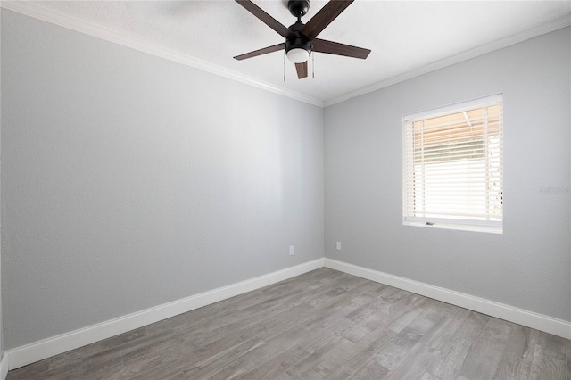 unfurnished room featuring crown molding, a ceiling fan, wood finished floors, and baseboards
