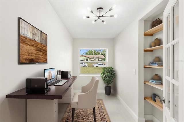 office space with an inviting chandelier, baseboards, and built in shelves