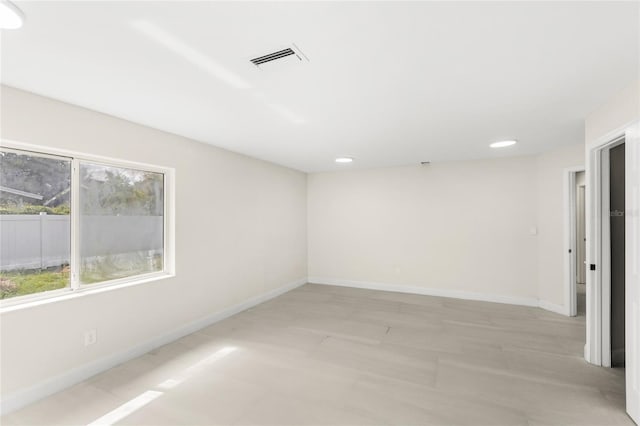 unfurnished room with recessed lighting, baseboards, and visible vents