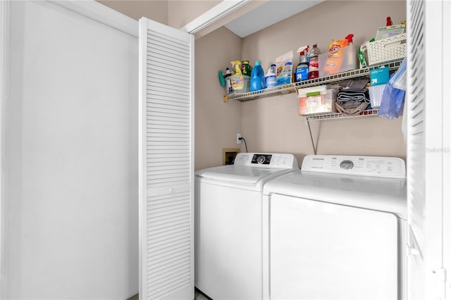 washroom featuring separate washer and dryer and laundry area