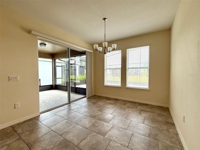 274 Brunswick Dr, Davenport, FL 33837 - spare room with healthy amount of natural light, baseboards, a chandelier, and a textured ceiling