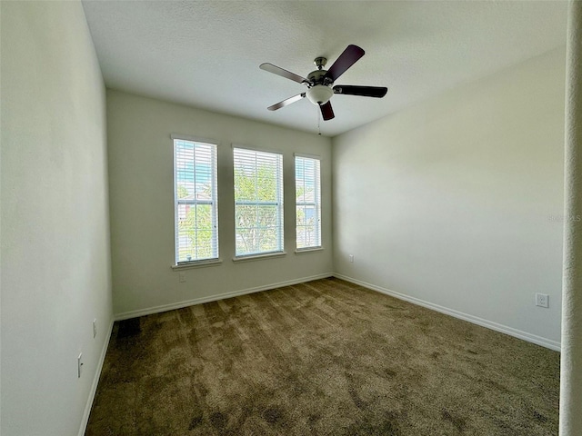 274 Brunswick Dr, Davenport, FL 33837 - empty room featuring baseboards, dark colored carpet, and ceiling fan