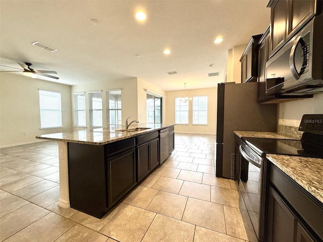 274 Brunswick Dr, Davenport, FL 33837 - kitchen featuring appliances with stainless steel finishes, a sink, a kitchen island with sink, recessed lighting, and light stone countertops