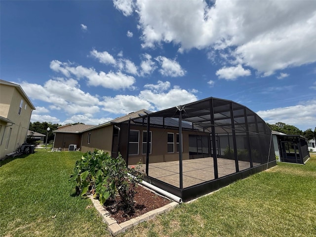 274 Brunswick Dr, Davenport, FL 33837 - back of house featuring a patio area, a yard, a lanai, and stucco siding