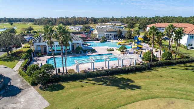 274 Brunswick Dr, Davenport, FL 33837 - community pool featuring a residential view, a water slide, a yard, a patio area, and view of wooded area