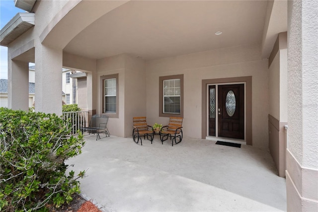 property entrance featuring stucco siding