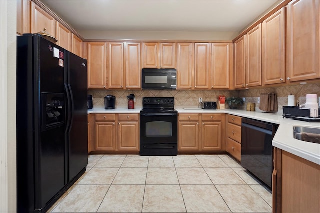 kitchen featuring light countertops, light tile patterned floors, backsplash, and black appliances